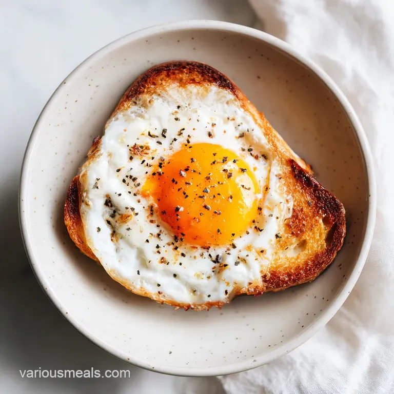 A single glistening air fryer egg, its white firm and yolk runny, rests atop toasted sourdough with chives.