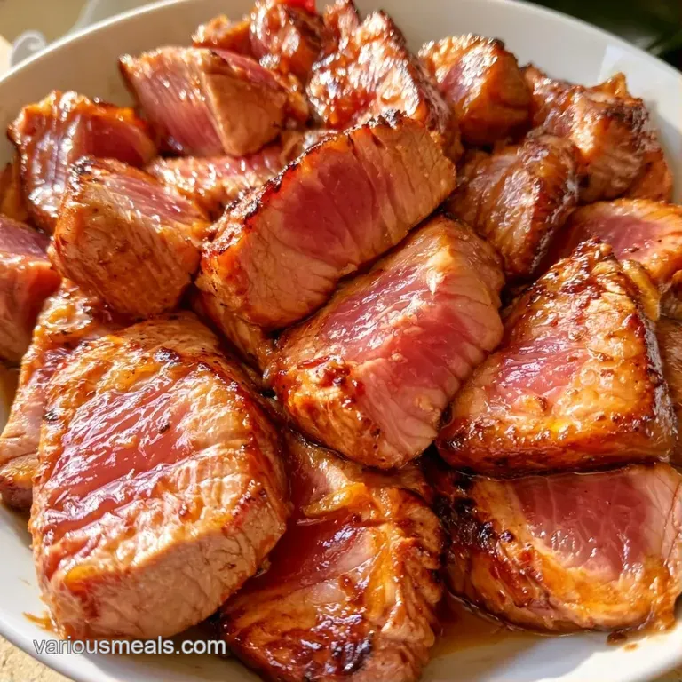 Perfectly seared tuna slices arranged on a slate platter with swirls of soy glaze and microgreen garnishes.