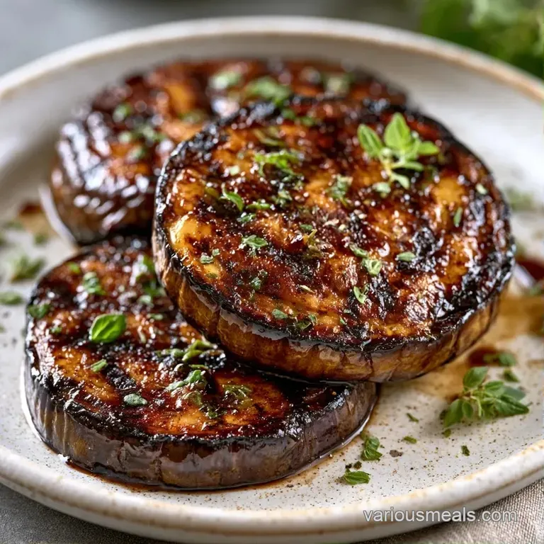 Charred purple vegetable rounds fanned on a platter, drizzled with dark glaze and topped with bright green parsley.