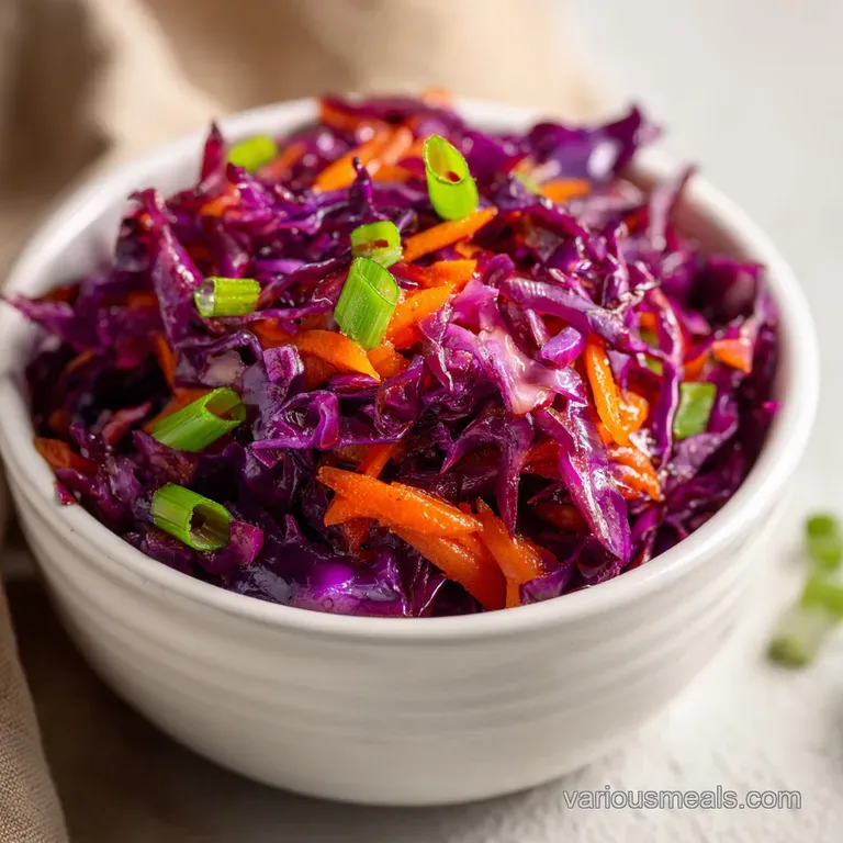 Crisp shredded cabbage and carrots piled high in a white ceramic bowl, garnished with a sprig of fresh parsley