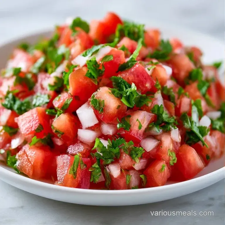 Vibrant green and red salsa served in a small bowl with salted corn tortilla chips on a rustic wooden board.