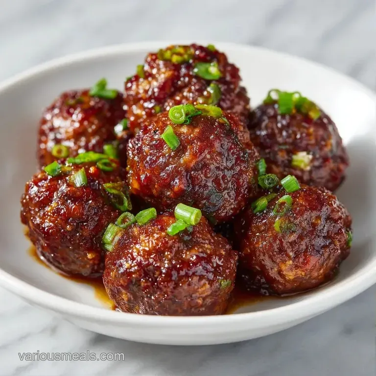 Glossy dark-brown spheres arranged on a slate board, garnished with sliced scallions and a drizzle of savory glaze.
