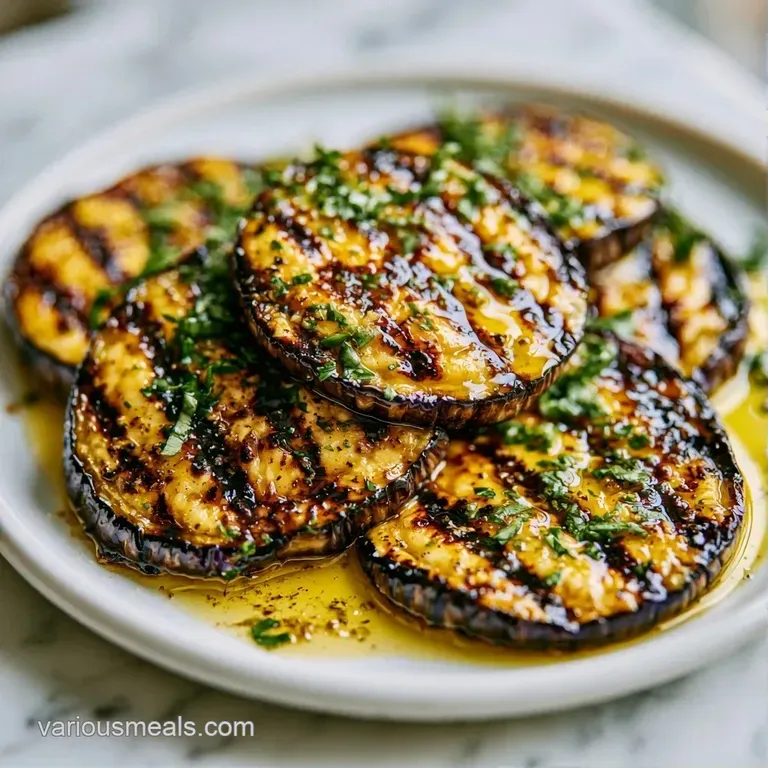 Artfully arranged smoky purple eggplant rounds topped with white cheese and bright green parsley on a ceramic dish.