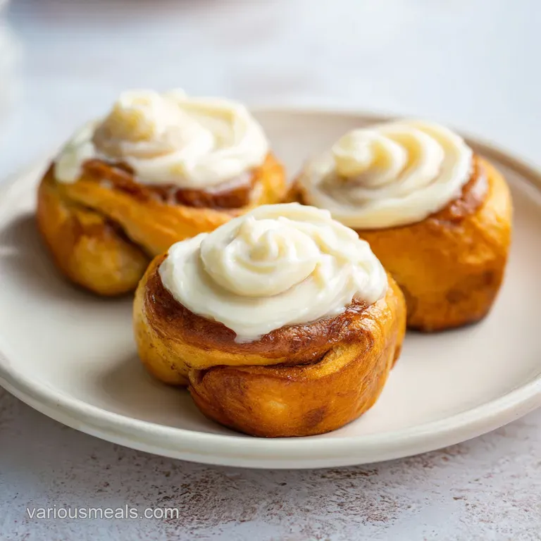 Miniature creamy cheesecake squares arranged on a white platter with fresh mint leaves and pineapple wedges.