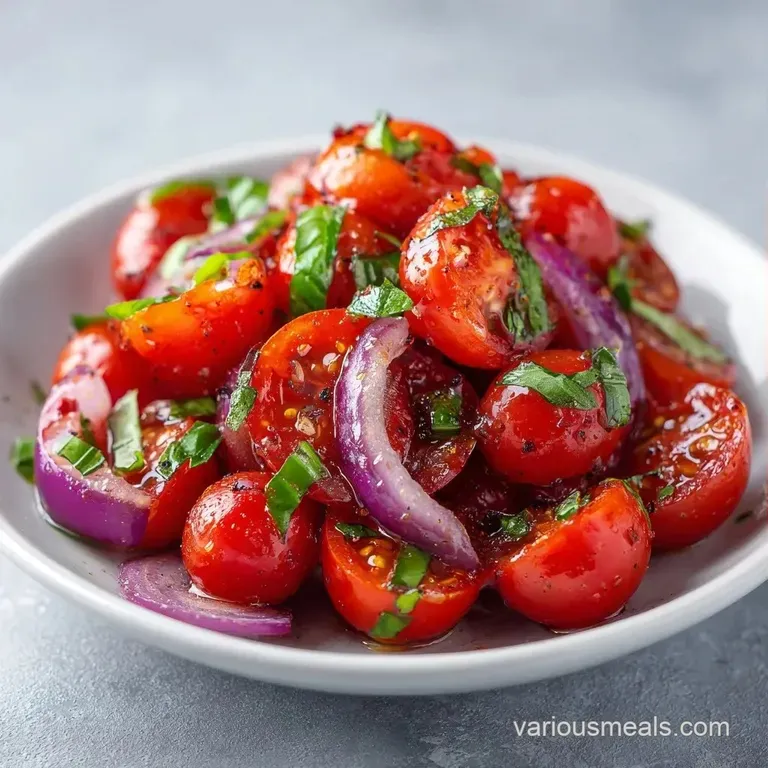 Sliced ruby tomatoes and thin purple onion rings arranged neatly on a white ceramic plate with a sprig of fresh parsley.