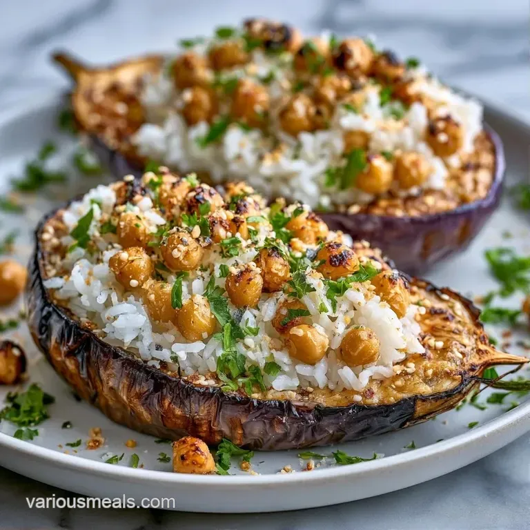 A roasted purple vegetable shell filled with fluffy white grains, drizzled with sauce on a slate serving platter.