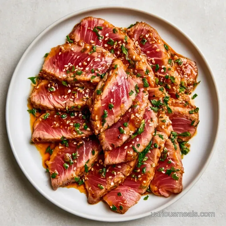 Seared tuna slices arranged neatly over a bed of steamed bok choy, drizzled with a glossy brown ginger glaze.